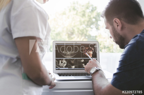 Male and female surgeon looking at an x-ray